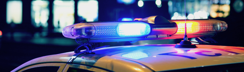 Close-up of red and blue lights on top of a police car