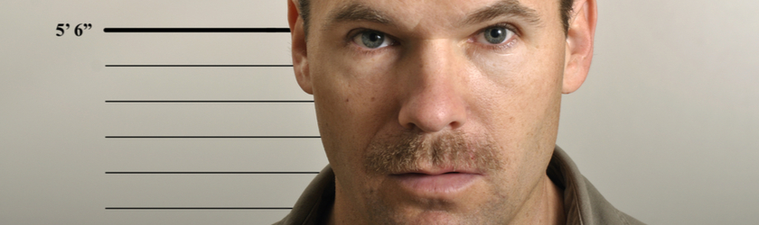 Close-up photo of a male suspect posing for a mugshot